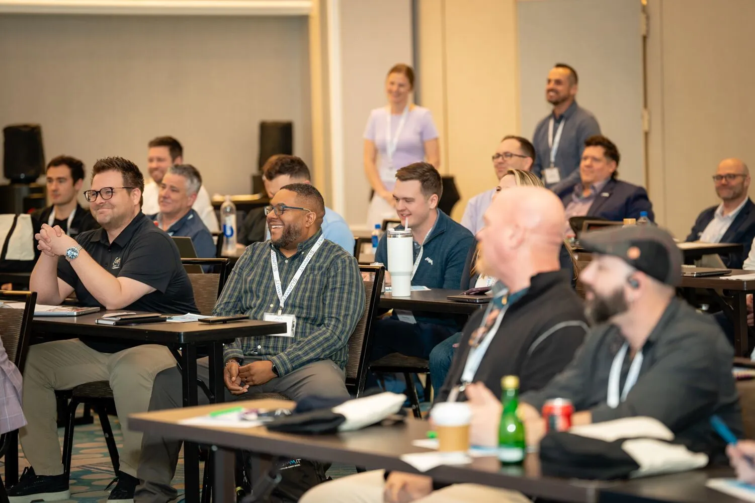 Summit customers and partners laughing during a Summit event session