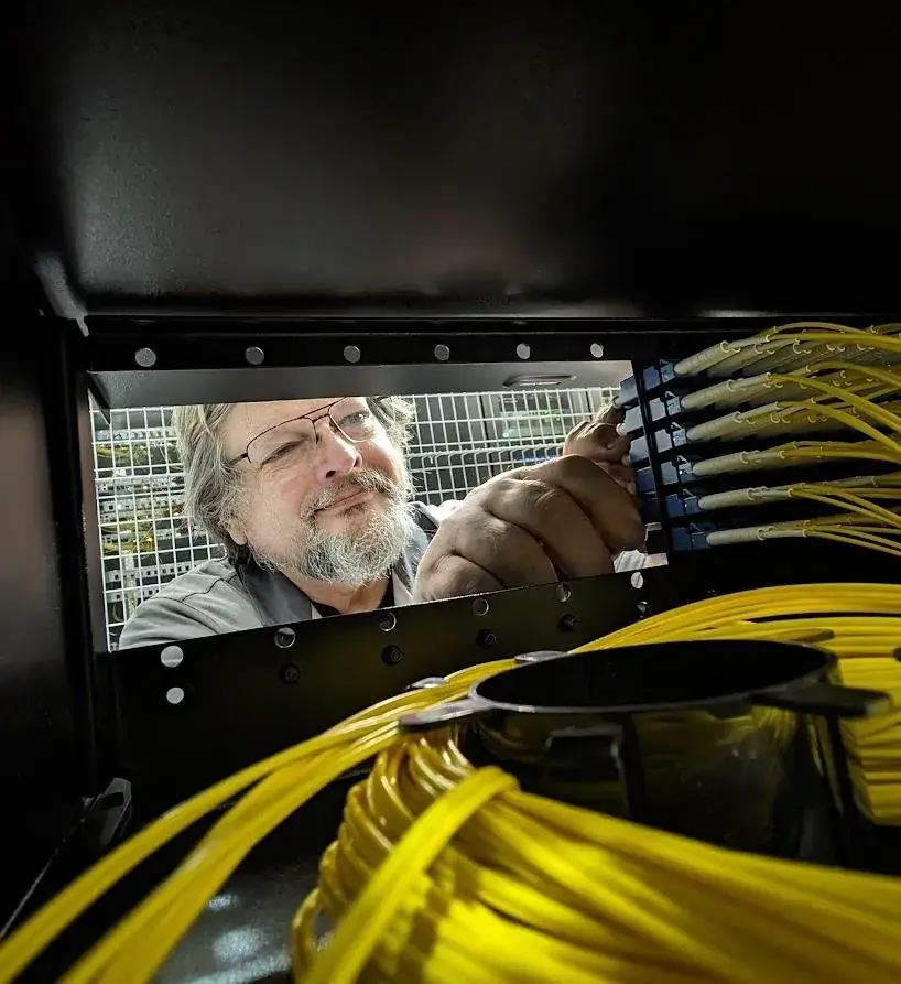 A Summit engineer connecting fiber inside a data center